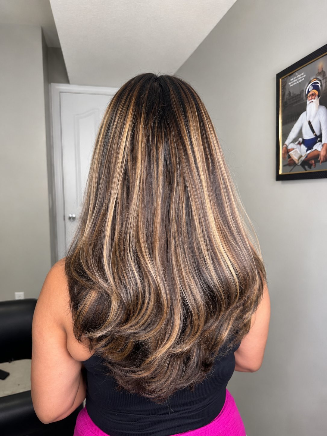 Golden caramel highlights on dark layered hair