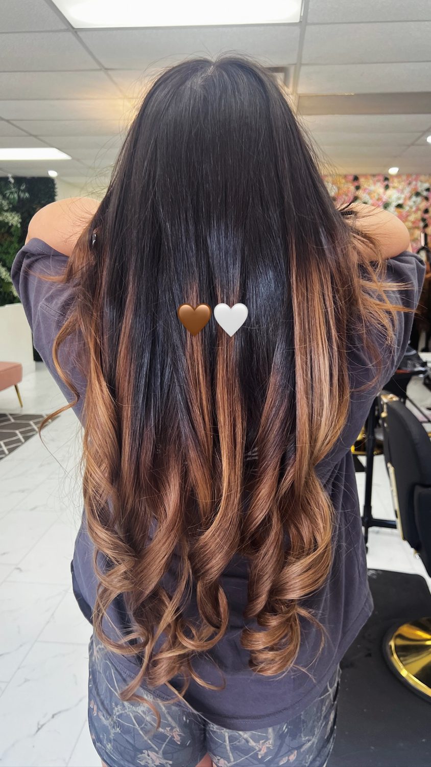 Caramel ombre with soft curls, dark roots melting to warm ends